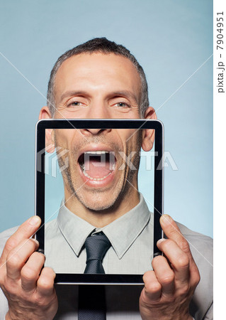 Man covering neck with digital tablet 7904951