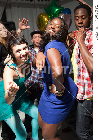 Woman wearing blue dress dancing at party 7905081