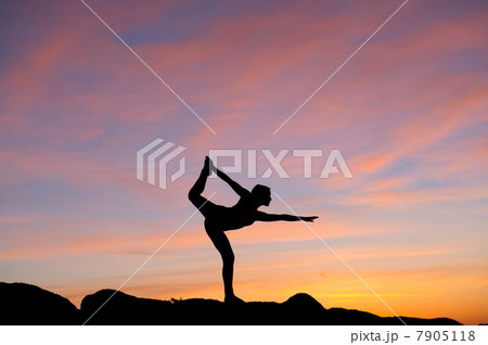 Young woman in dancer pose in desert, silhouette 7905118