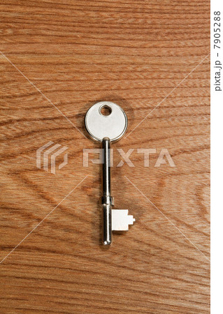 Key against wooden background Key against wooden background 7905288