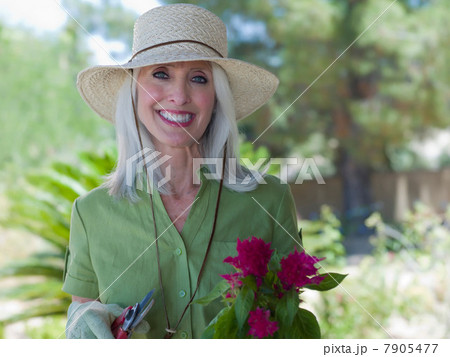 Older woman gardening outdoors 7905477
