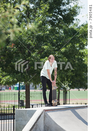 Skateboarder on ramp at skate park 7905481