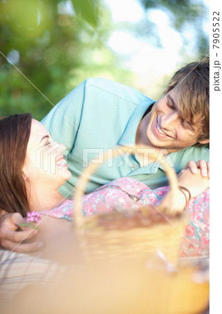 Couple relaxing on picnic blanket Couple relaxing on picnic blanket 7905522