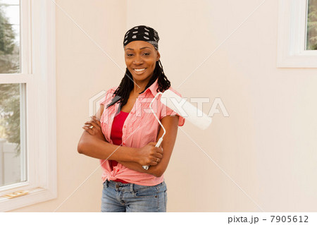 Woman painting in new home 7905612