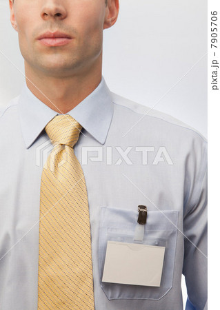 Young man wearing tie and name badge Young man wearing tie and name badge 7905706