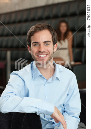 Happy young man and woman in background 7905832