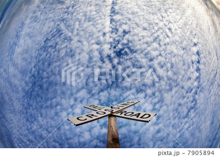 'Railroad crossing' sign under blue sky 7905894