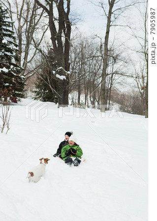 Two children sledging in snow Two children sledging in snow 7905987