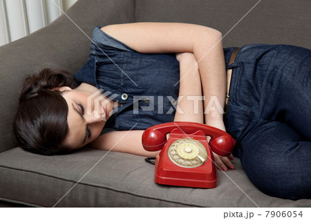 Woman lying on sofa with telephone Woman lying on sofa with telephone 7906054