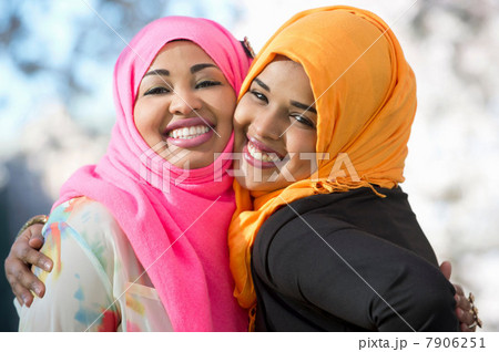 Close up portrait of two young woman in park Close up portrait of two young woman in park 7906251