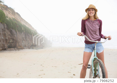 Woman on bicycle on beach Woman on bicycle on beach 7906252