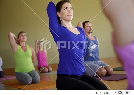 Men and women practicing yoga in exercise studio Men and women practicing yoga in exercise studio 7906265