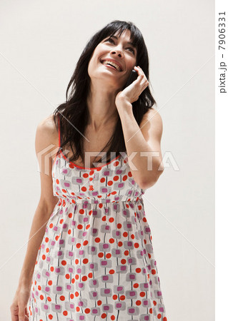 Smiling mature woman using cellphone, studio shot Smiling mature woman using cellphone, studio shot 7906331