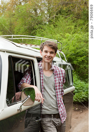 Young man by camper van 7906669