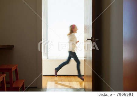 Girl running past doorway 7906991