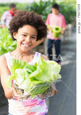 Girl holding lettuce in nursery 7907009