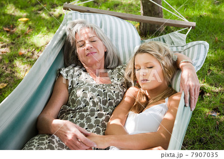Mother and daughter relaxing in hammock Mother and daughter relaxing in hammock 7907035