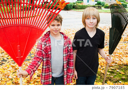 Two boys holding rakes 7907185