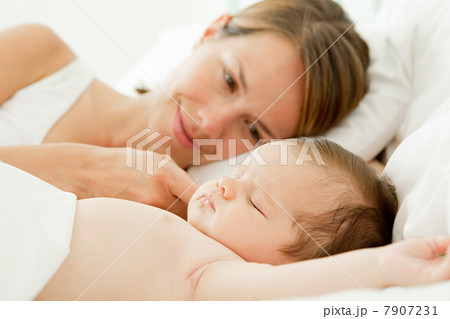 Mother watching baby girl sleep 7907231