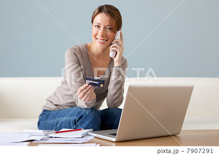 Young woman on the phone with laptop 7907291