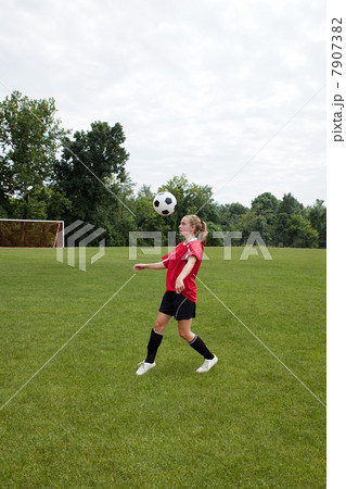 Girl soccer player with ball 7907382