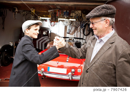 Grandfather and grandson shaking hands 7907426