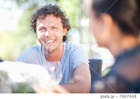 Friends having drinks at table outdoors 7907438