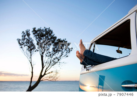 Feet out of camper van window at dusk Feet out of camper van window at dusk 7907446