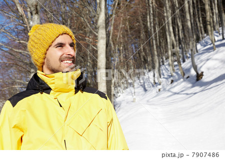 Portrait of man wearing yellow knit hat and coat Portrait of man wearing yellow knit hat and coat 7907486