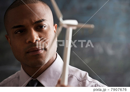 Man with model wind turbine 7907676