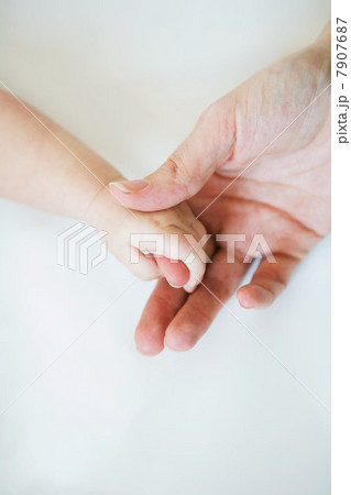 Adult holding baby hand 7907687
