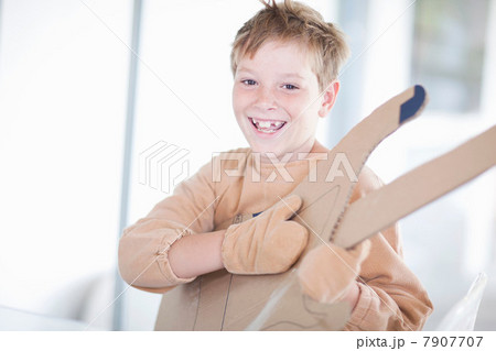 Boy playing the guitar Boy playing the guitar 7907707