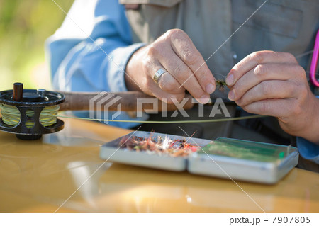 Mature woman preparing bait for fly fishing, close up 7907805