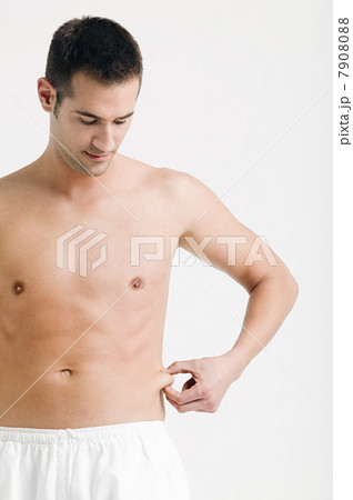 Young man pinching waist 7908088