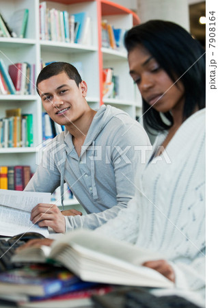 University students reading textbooks in college library, portrait 7908164