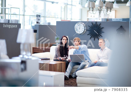 Couple shopping with salesman in store 7908335