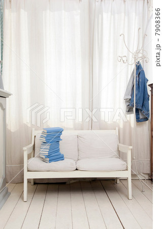 Empty seat with pile of blue books 7908366