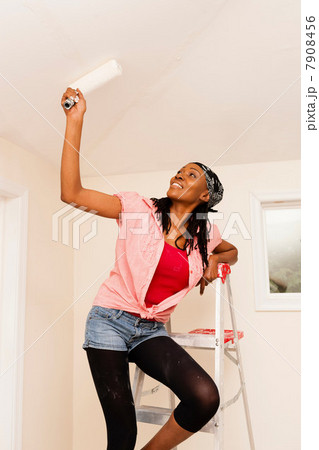 Woman painting in new home Woman painting in new home 7908456