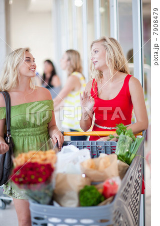 Women pushing shopping cart Women pushing shopping cart 7908479