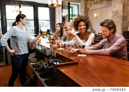 Customers drinking at bar 7908484