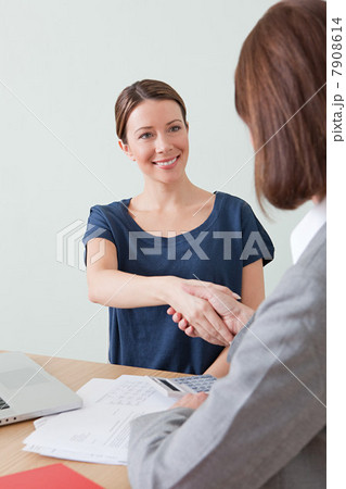 Young woman shaking hands with financial adviser 7908614