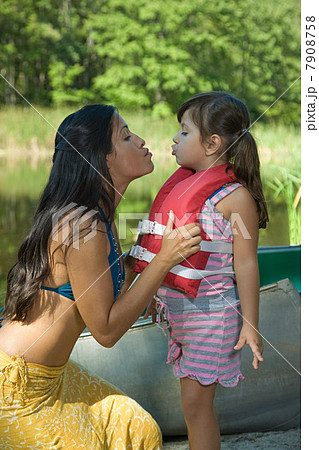 Mother and daughter making kissing faces Mother and daughter making kissing faces 7908758