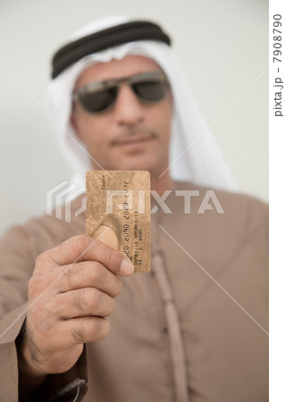 Middle eastern man holding credit card 7908790