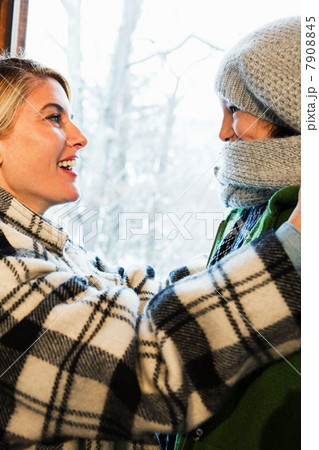 Mother putting scarf on daughter 7908845