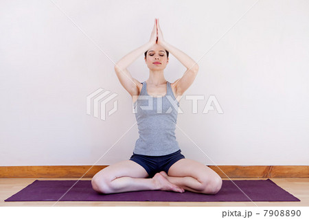 Woman in prayer position during yoga 7908890