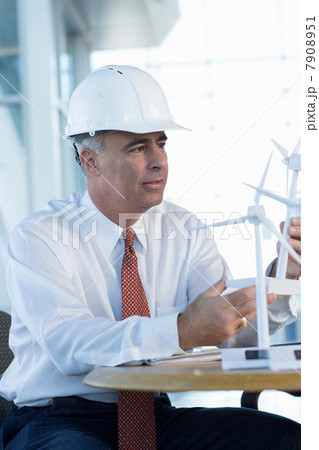 Engineer with model wind turbines 7908951