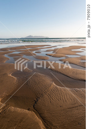 Water making patterns in sand on beach Water making patterns in sand on beach 7909010