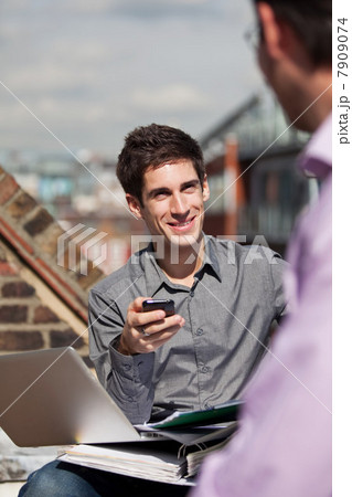 Two men in a meeting in a roof garden 7909074
