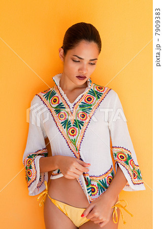 Woman against yellow wall Woman against yellow wall 7909383
