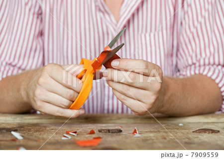 Person cutting paper 7909559